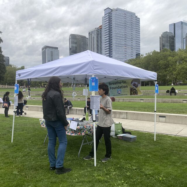 Community members visiting the Breathe-On booth